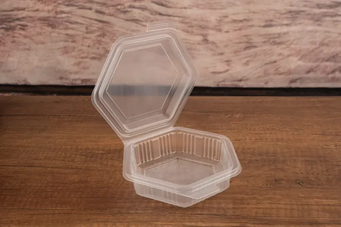 Technical detail of Packmaster CF10 375 cc hexagonal container showing open lid and tamper-evident security lock.